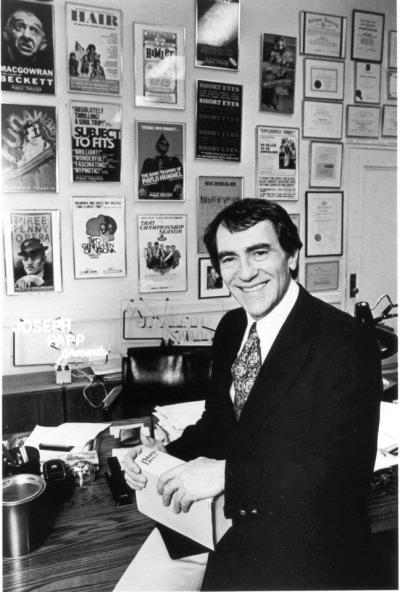 Joseph Papp in front of posters for his many legendary productions
